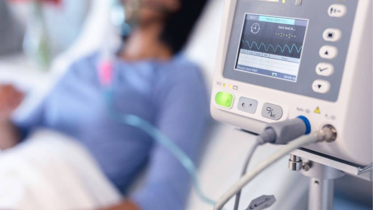 Respiratory therapist checking ventilator in hospital